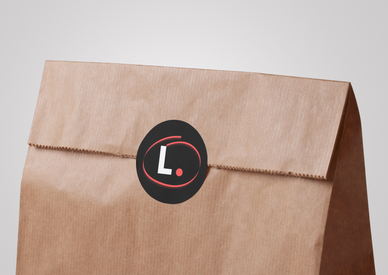 a business logo sticker on a brown paper bag