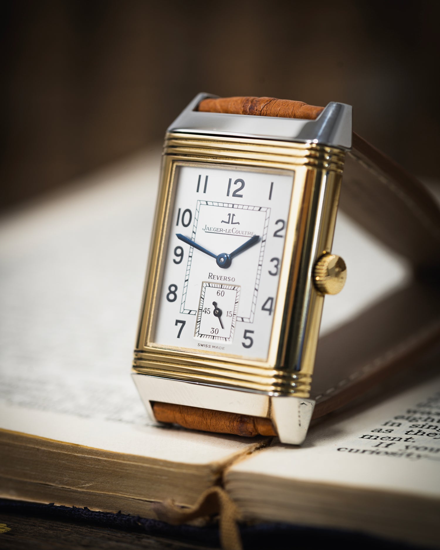 A bi metal jaeger-lecoultre photographed on an open book
