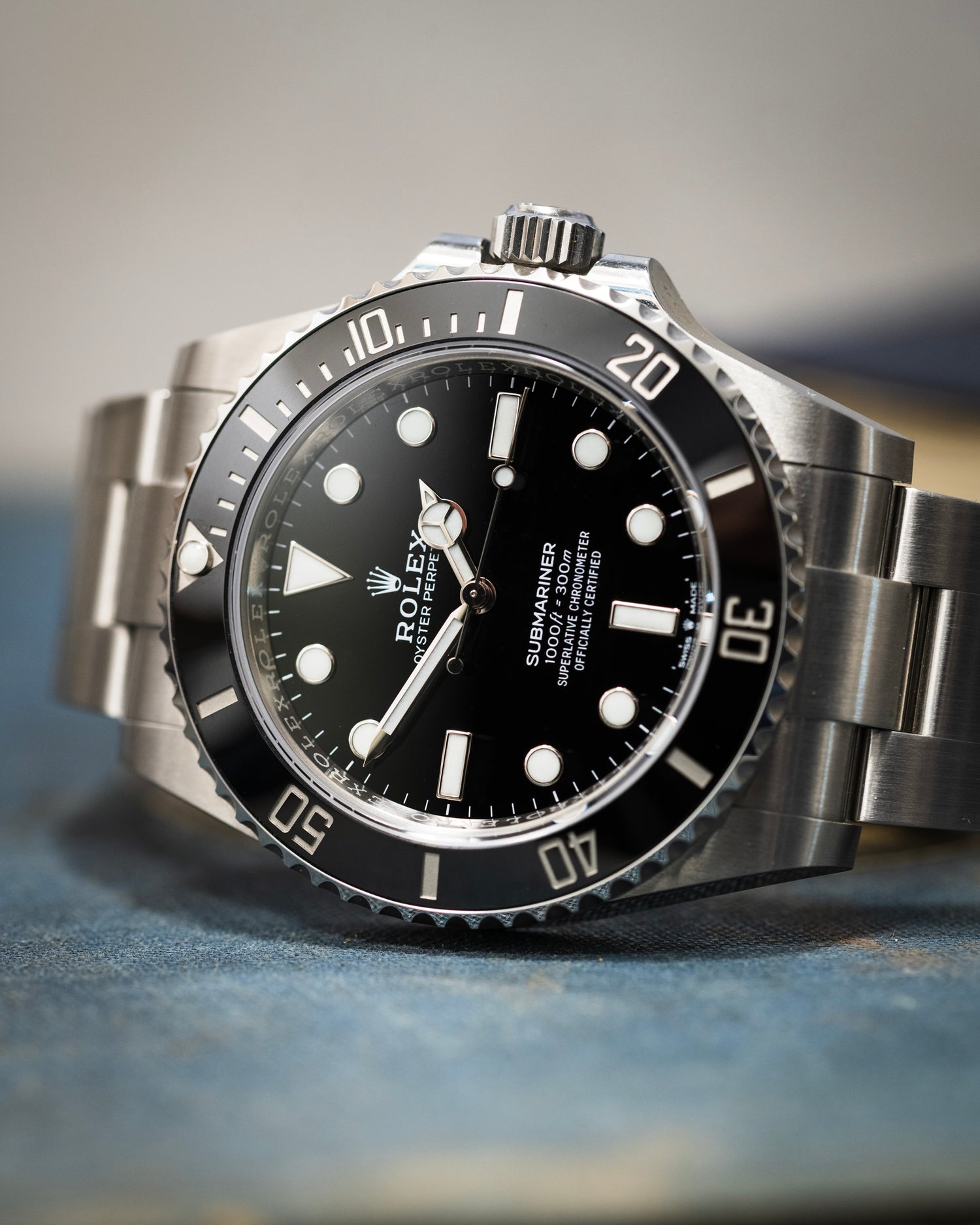 Rolex Submariner in stainless steel photographed on a blue base