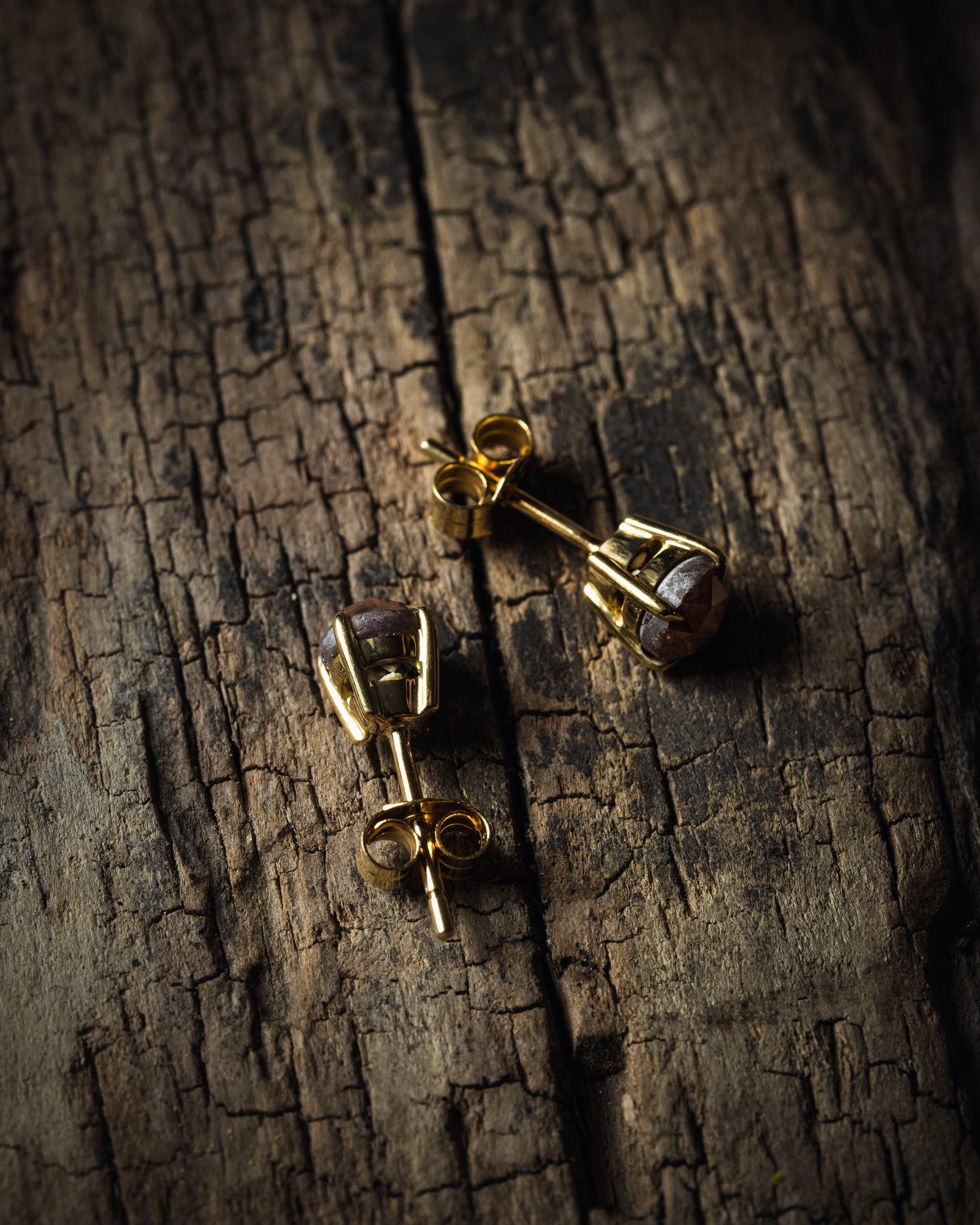 salt and pepper diamond earrings photographed on a wooden base