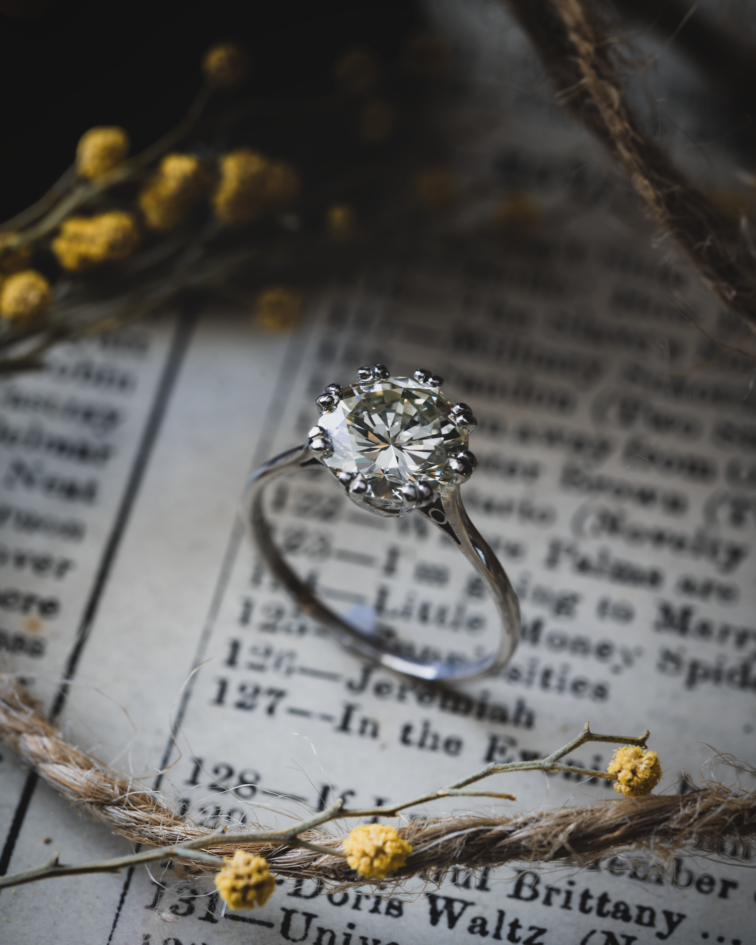 Vintage 2ct Diamond Ring photographed on paper with rope and yellow flower