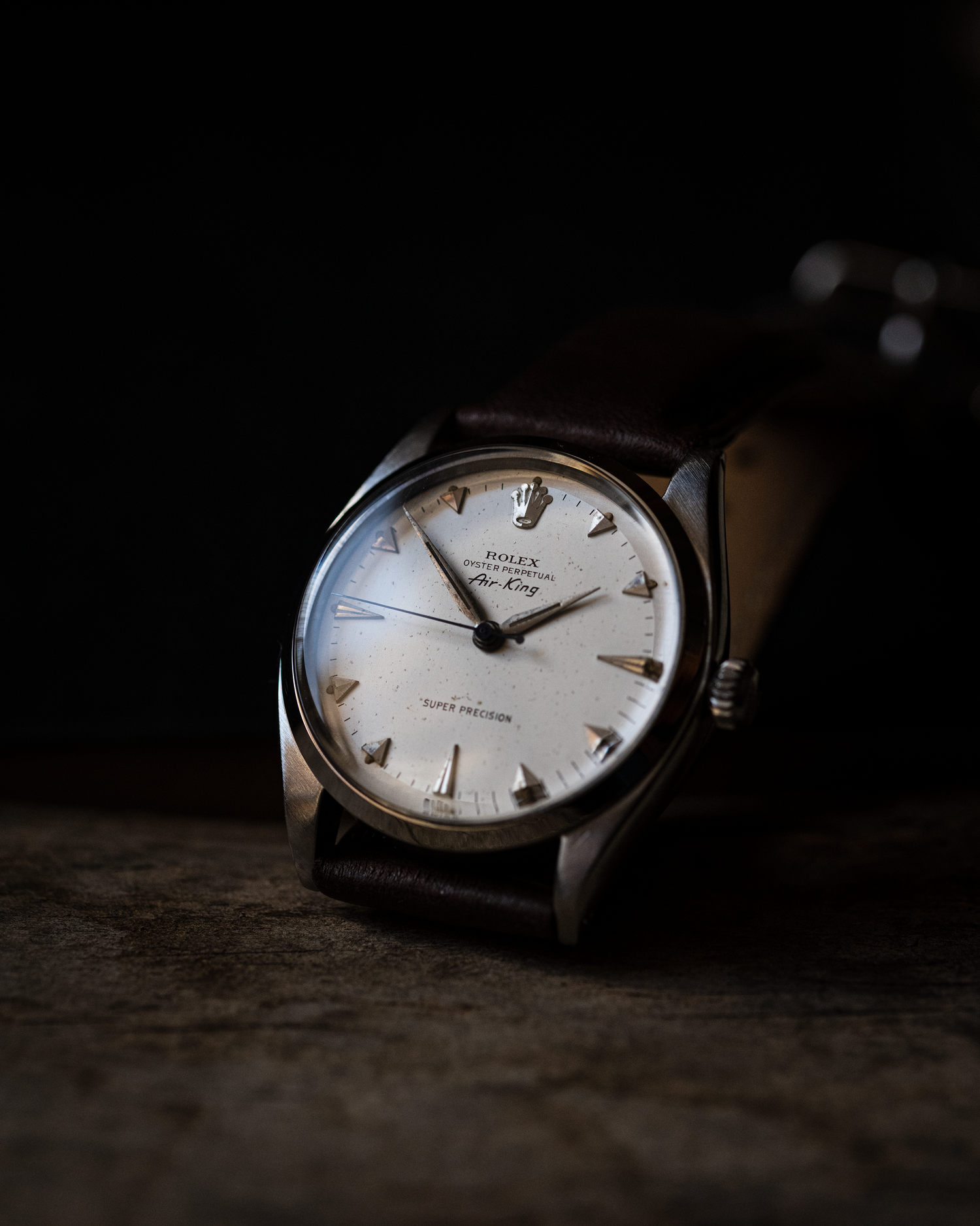 Vintage Rolex Airking photographed on a dark background